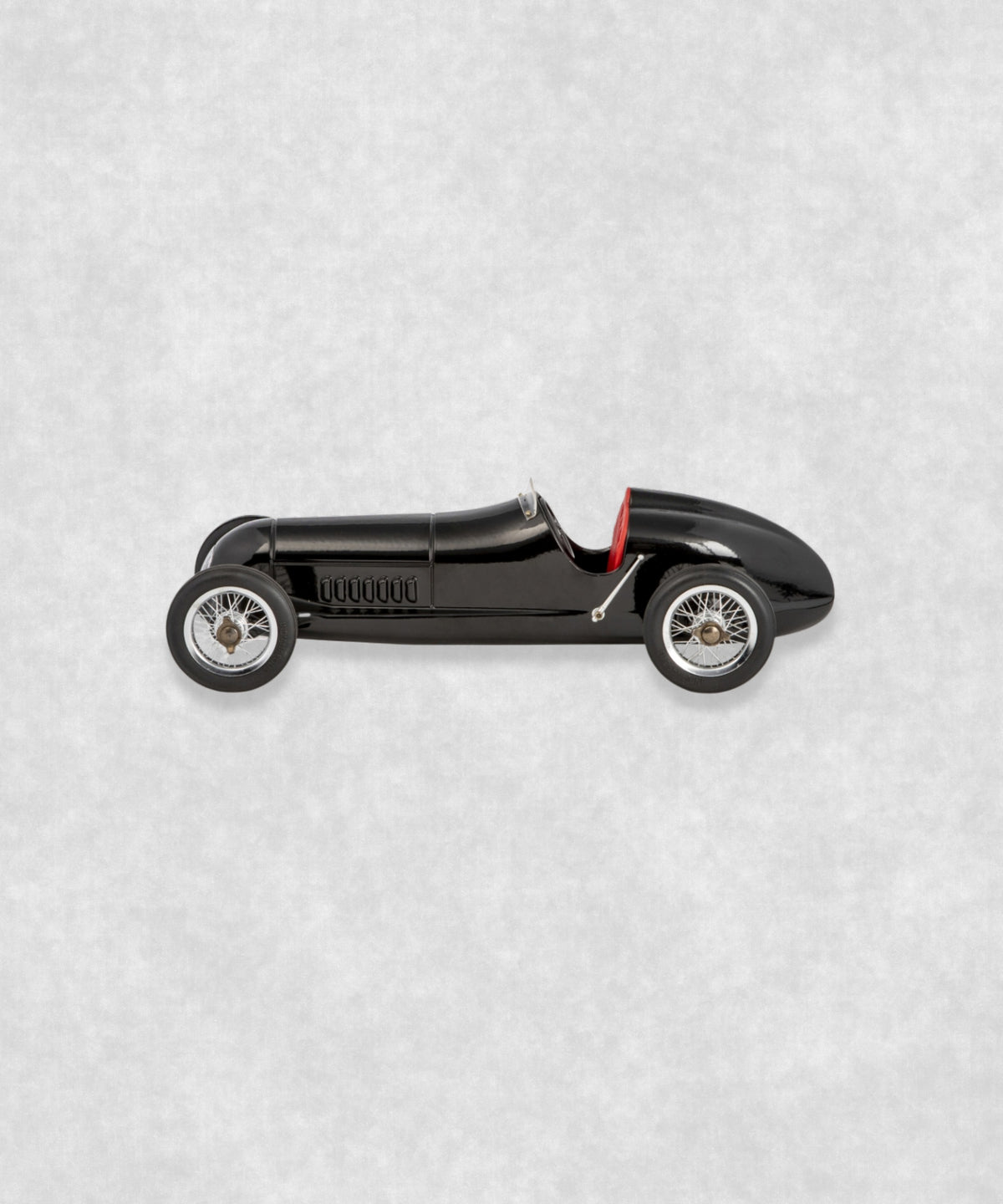 Vintage racing silberfeil car  model inspired by classic Grand Prix racers and Silver Arrow legends, featuring a sleek black race car body with a striking red seat. A collectible car model for motorsport and classic car enthusiasts. Viewed from  the right side.