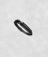 Side view of a white gold-coated bracelet featuring a large centerpiece set with 37 diamonds and a flexible black rubber band.
