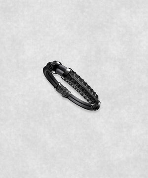 Side view of a white gold-coated bracelet featuring a large centerpiece set with 37 diamonds and a flexible black rubber band.